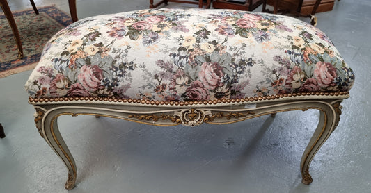 Antique painted Louis XV style upholstered stool. It has lovely floral upholstery that is in good condition with no tears. It is in good original detailed condition.