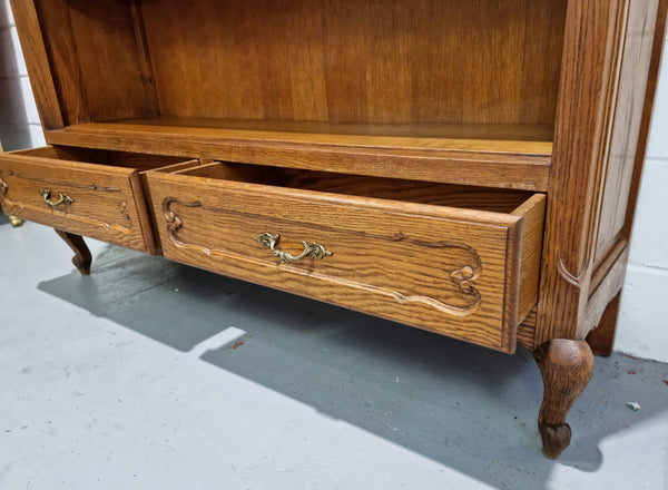 Lovely French Oak Louis XV style open shelf bookcase with two drawers for storage and three shelves in good original detailed condition.