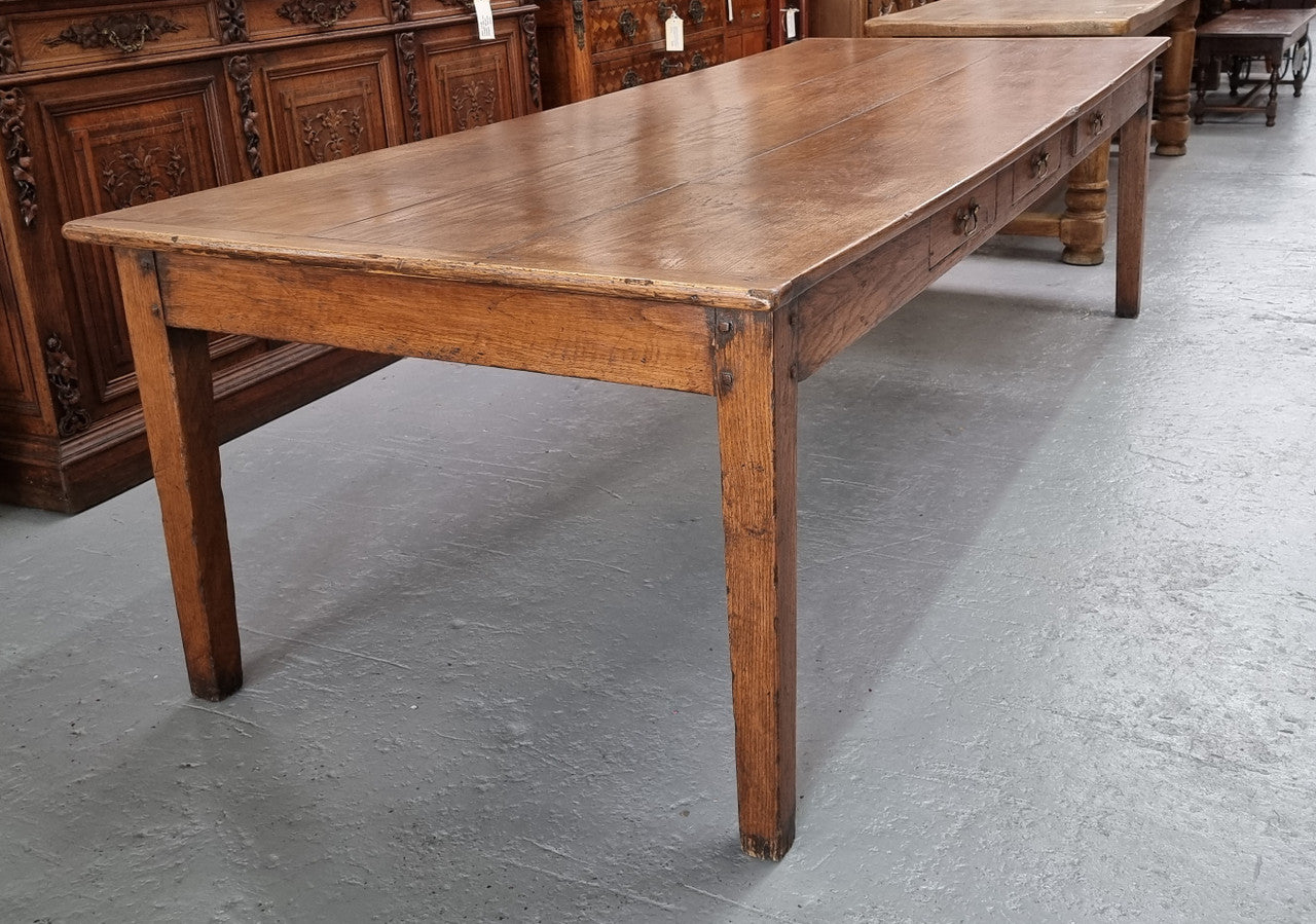 Amazing 19th Century French Oak Farmhouse style dining table with three drawers. It is made from three large planks of wood which is very hard to find. It is also very wide with a width of 105.5 cm. It is in good original detailed condition.