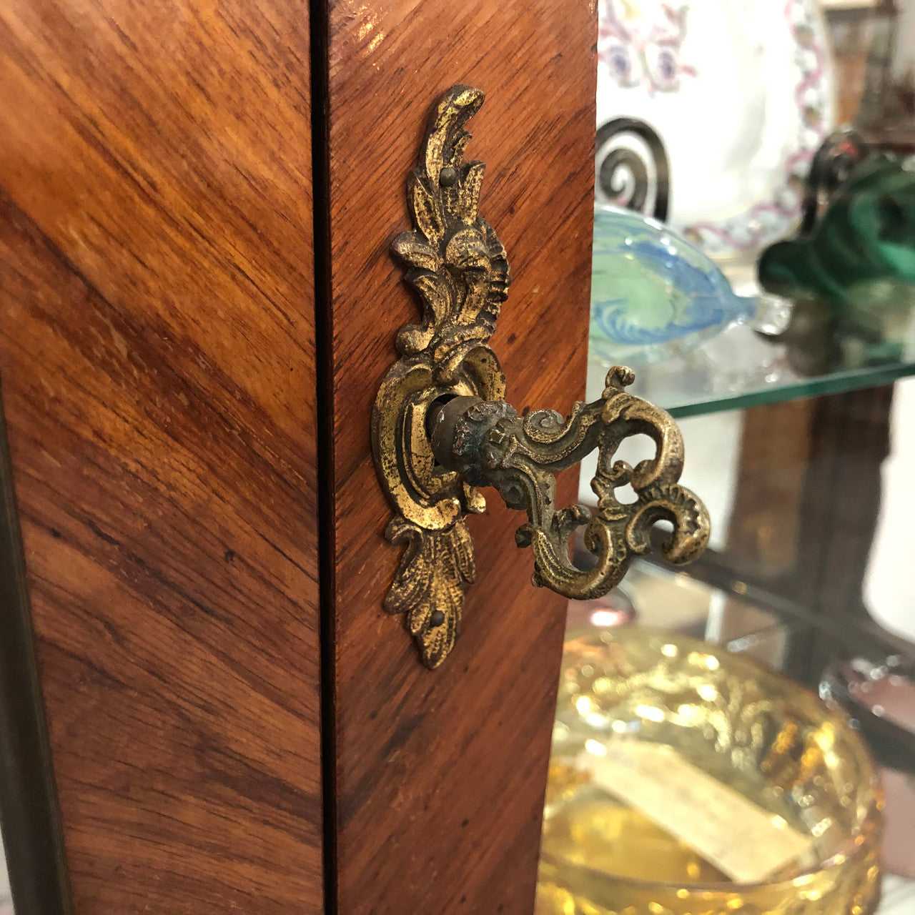 A Louis XV style Kingwood vitrine with marble top. It has beautifully floral inlay with ormolu mounts.