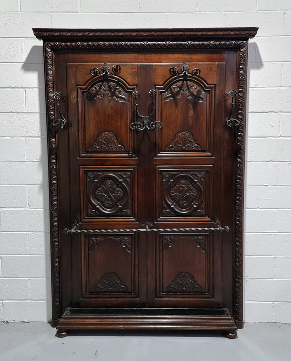 French Henry II 19th century narrow proportioned Walnut hall stand. Full of Character with stunning hand forged wrought iron hooks and interesting carvings. In good original detailed condition.