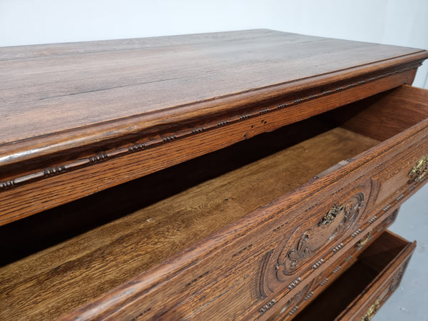 Early 19th Century French Oak chest of three drawers. It has beautiful handles and carvings. It is in good original detailed condition.