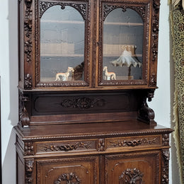 Grand French Oak Gothic style buffet with amazing detailed carvings. This stunning buffet has a display section at the top with two adjustable shelves, two drawers in the middle with elegantly carved handles and storage below with one fixed shelf. It is in good original detailed condition.