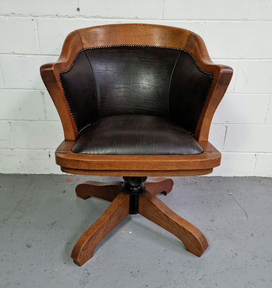 Antique French Oak newly upholstered "swivel action" office desk chair. In very good condition and very comfortable to sit in.