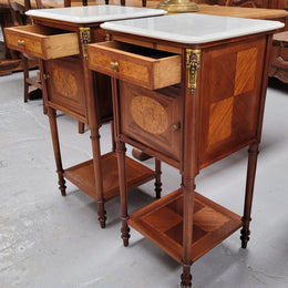 Pair of white marble topped Louis 16th style bedside cabinets consisting of one drawer and one cupboard.  Inlaid with burr walnut and has decorative mounts. They have been sourced from France and are in good original condition.