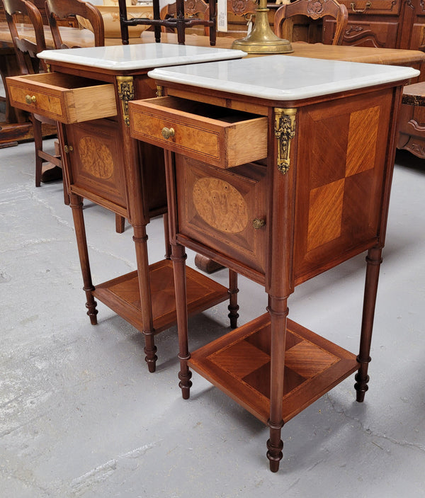 Pair of white marble topped Louis 16th style bedside cabinets consisting of one drawer and one cupboard.  Inlaid with burr walnut and has decorative mounts. They have been sourced from France and are in good original condition.