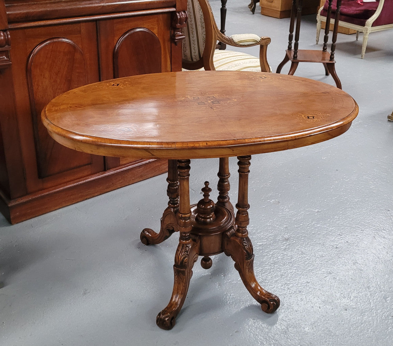 Victorian Walnut oval beautifully inlaid occasional table with bird cage undercarriage. It is in good original detailed condition and it has been sourced locally.