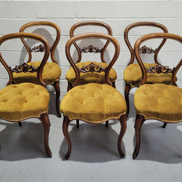 Set of six upholstered Victorian balloon back chairs. In good original detailed condition.