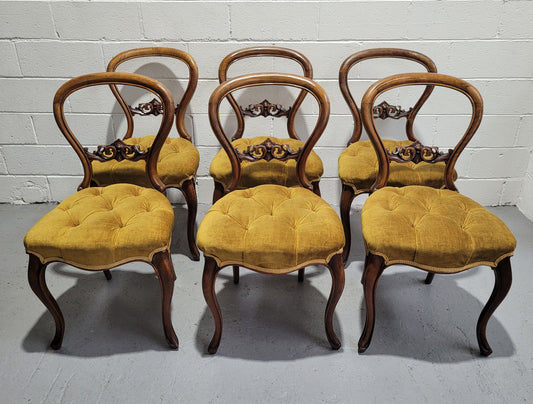 Set of six upholstered Victorian balloon back chairs. In good original detailed condition.