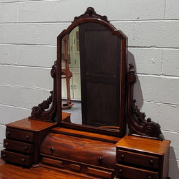 Beautiful Flame Mahogany Victorian duchess dressing table. Circa 1880 in date. It has a serpentine front outline and has an adjustable swing frame mirror. It is fitted with a central roll up storage section and then has three small drawers to either side, aswell as a central drawer in the middle of the serpentine front. It is in good original condition.