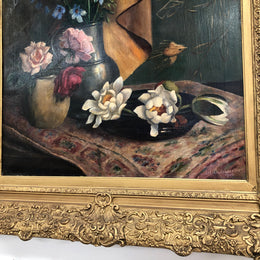 An Antique gilt-framed oil painting of floral still life. Housed in a double sweep gilt frame, signed and dated in good condition.