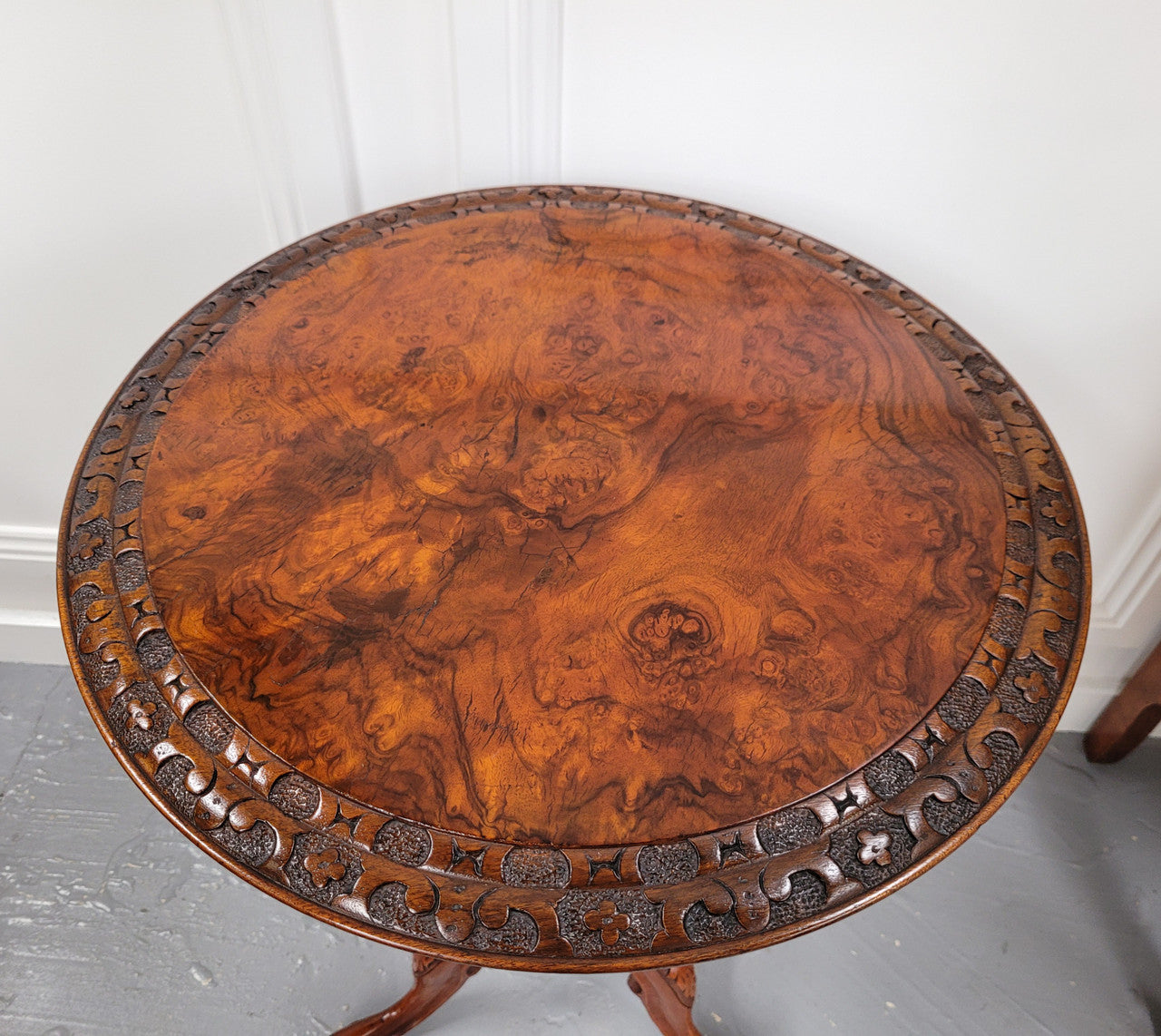Rare early Victorian Irish Burr Walnut wine table. It has a beautiful carvings and a stunning burr walnut top, on a barley twist column and three shaped legs. It has been sourced locally and is in good original detailed condition. We also have a second table being sold separately which when together make a matched pair.