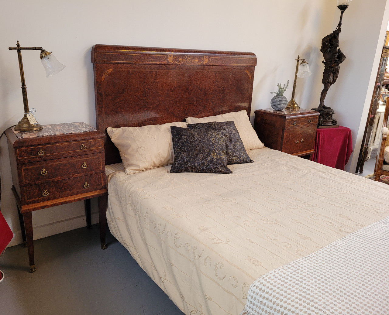 French Art Deco bedroom suite consisting of queen size bed in Amboyna wood and featuring pretty inlay. It comes with a matching pair of bedsides. It is a very stylish and high quality suite. It has been sourced from France and is in good original detailed condition.