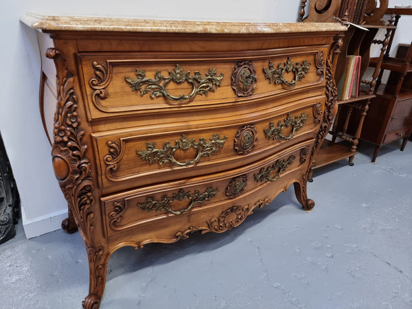 Impressive Louis XV style three drawer walnut commode. Ormolu handles and bevelled marble top complimenting detailed carving. In very good original detailed condition.