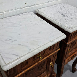 Lovely pair of French Oak carved Louis XV style bedside cabinets with a white marble top, drawer and cupboard in good original detailed condition.