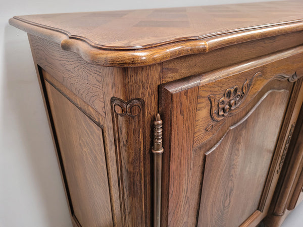 French Oak Louis XV style three door, two drawer, parquetry top sideboard. It has been sourced from France and is in good restored condition.