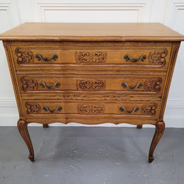 French Oak Louis 15th style nicely carved three drawer wooden top commode. It has been sourced from France and is in good original detailed condition.