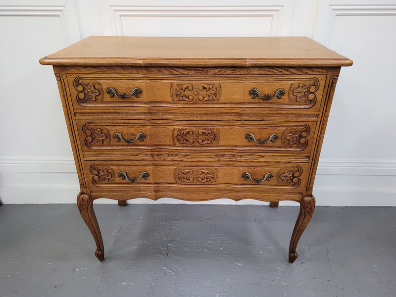 French Oak Louis 15th style nicely carved three drawer wooden top commode. It has been sourced from France and is in good original detailed condition.