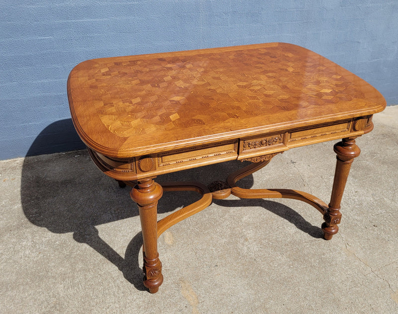 Beautiful carved French Oak dining table with a parquetry top and six matching upholstered chairs. All in good original detailed condition.