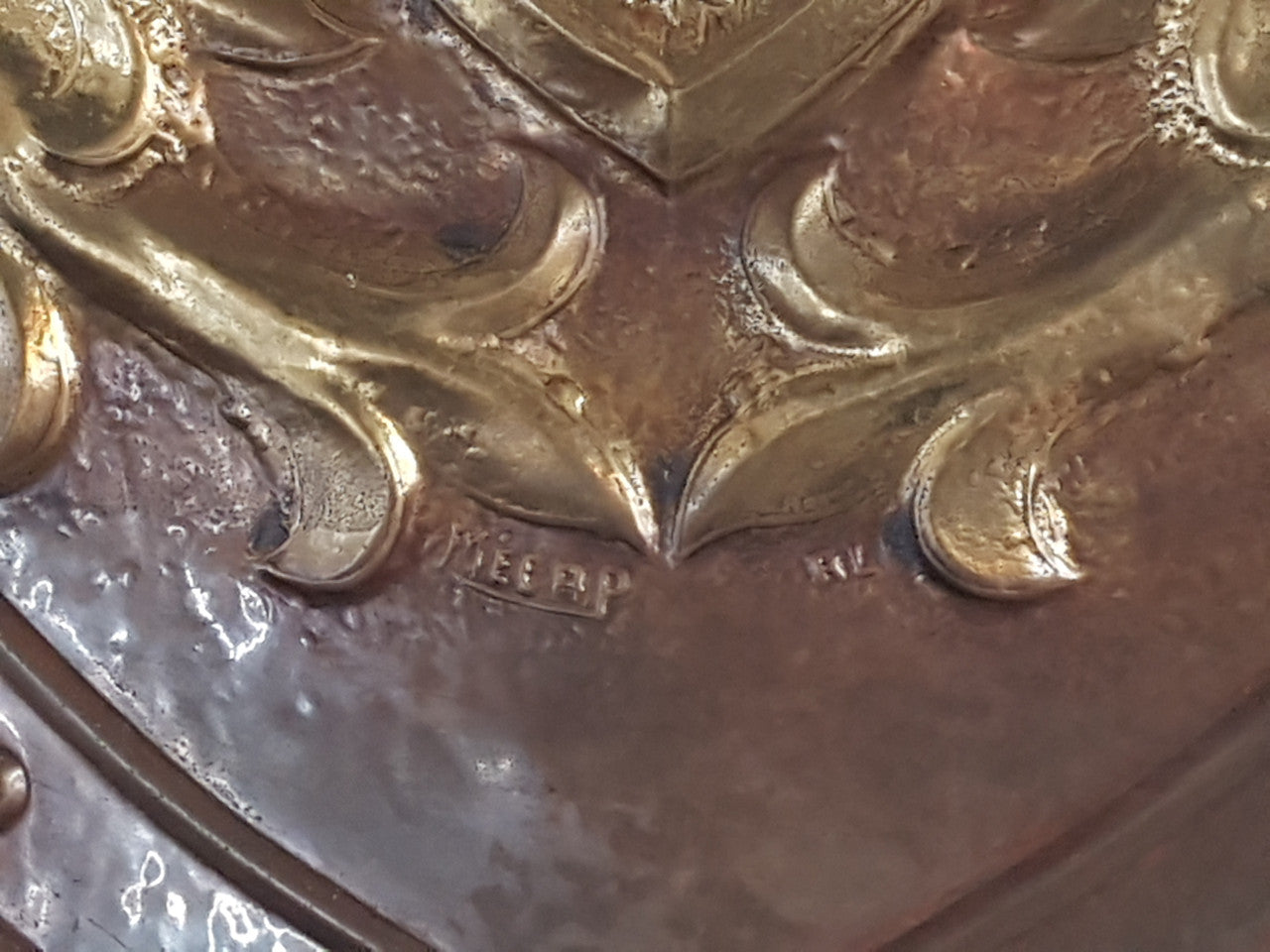 An Antique Embossed Shield with Swords