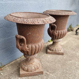 Beautiful pair of French rustic cast iron urns with handles. They would look fabulous in the garden or inside. They are very heavy an in good original condition.