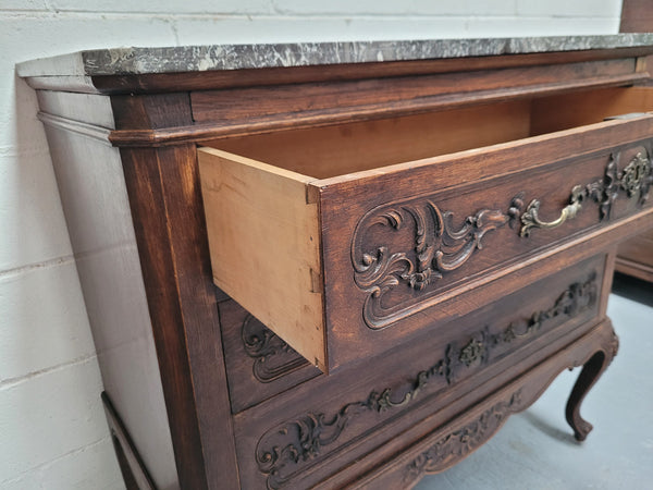 French Oak Louis XV style marble top chest of three drawers. It has beautiful carvings on the drawers with lovely decorative handles all toped with a stunning black and white marble top. In good original detailed condition.