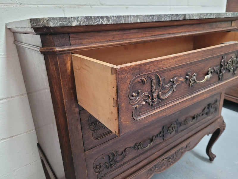 French Oak Louis XV style marble top chest of three drawers. It has beautiful carvings on the drawers with lovely decorative handles all toped with a stunning black and white marble top. In good original detailed condition.