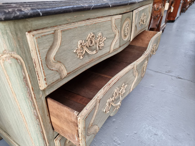 Early 19th Century Louis XIV style faux marble top and painted base commode. It is of large proportions and has four drawers. In good original detailed condition.