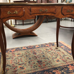 An impressive French Walnut petite Bureau Plat with superb ormolu mounts, original tooled leather top with loads of character and drawers for storage. It is in very good original detailed condition.