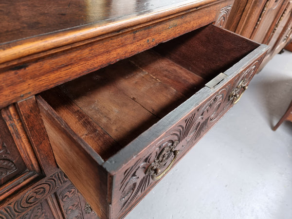 Impressively carved 18th Century English Oak kitchen dresser in 17th Century Jacobean style. It is in good original detailed condition and has been sourced from France.
