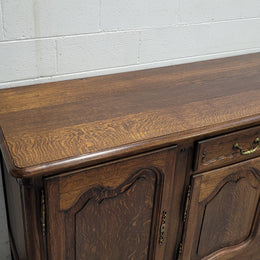 Late 19th Century French carved Oak Louis XV style four drawer sideboard. Plenty of storage space with four cupboards and two drawers. It is in good original detailed condition with all locks functioning with keys.