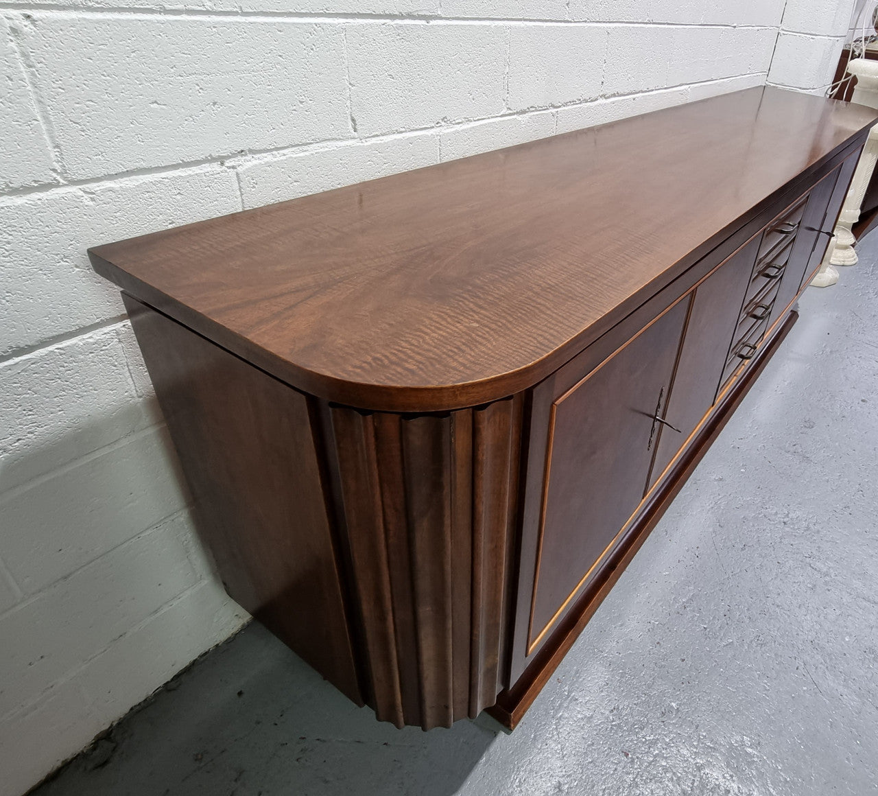 Amazing French Walnut Art deco four door buffet. The doors either side open to a fixed shelf and plenty of added storage with four drawers. In good original detailed condition.