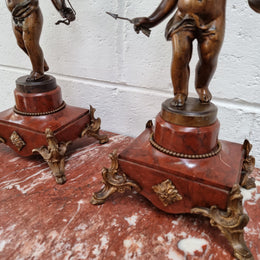Pair of highly decorative French cherub candelabras with bronzed metal and marble. In good original detailed condition.