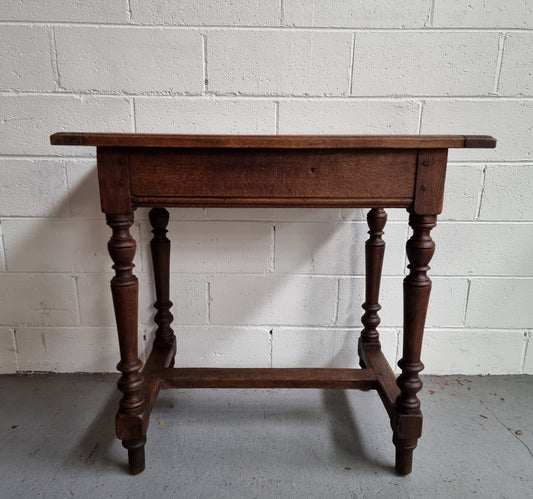 Rustic French Oak side table/desk with turned legs. In good original condition.