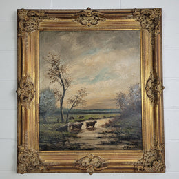 A stunning painting sourced in France signed oil on canvas of "Cows In River Landscape". Framed in a magnificent gilt frame and is in good original detailed condition.