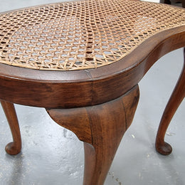 Hard to find English stool with cane top. Kidney shaped with beautiful cabriole legs and is in good original condition.