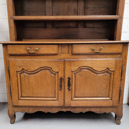 Charming 18th Century French Oak Vaisselier / kitchen dresser with two cupboard doors and three open shelves at the top. Sourced from France and in good original detailed condition.
