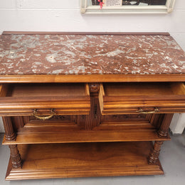 Stunning Henry II style French Walnut marble top buffet. It has a beautiful marble top and plenty of storage with two drawers, two doors with beautiful decorative carvings and an open shelf. It has been sourced from France and is in good original condition and has been detailed to a high standard.