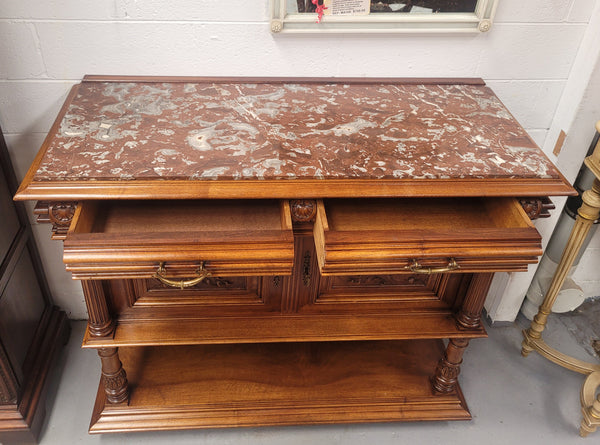Stunning Henry II style French Walnut marble top buffet. It has a beautiful marble top and plenty of storage with two drawers, two doors with beautiful decorative carvings and an open shelf. It has been sourced from France and is in good original condition and has been detailed to a high standard.