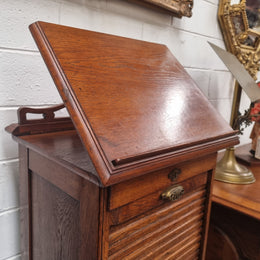 Antique Edwardian roll top Tambour file cabinet desk. This practical antique tambour front filing cabinet dates around 1900 in the Edwardian period and is constructed from Oak. This antique cabinet has an adjustable writing slope, above a tambour front with key and working lock. It has been sourced locally and is in good original detailed condition.