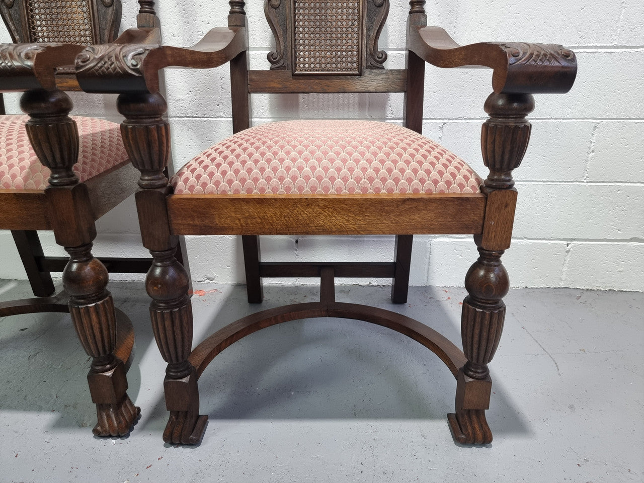 Pair oak Jacobean Revival carver chairs with cane back. In good restored condition with clean upholstery.