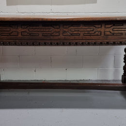 Rare and Charming 17th Century Spanish Walnut serving / side table. It has an incredible one piece walnut top with amazing character and colour. The base displays the original patina aswell as three drawers with carving and remnants of original locks. Superbly turned legs terminating on a stretcher base. Could be used as a large entrance console table, a side table or in a dining area as a serving table. In good original detailed condition especially considering its age.