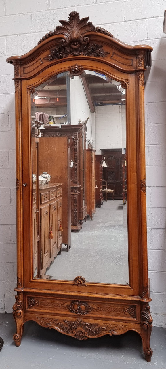 French single door Walnut Louis XV style armoire with mirrored door. In good orignal detailed condition.