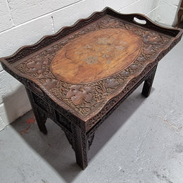 Anglo Indian folding occasional table with lift-up tray top. The tray has brass inlay and ornate carvings. The bottom of the table folds down and it is in good original condition.