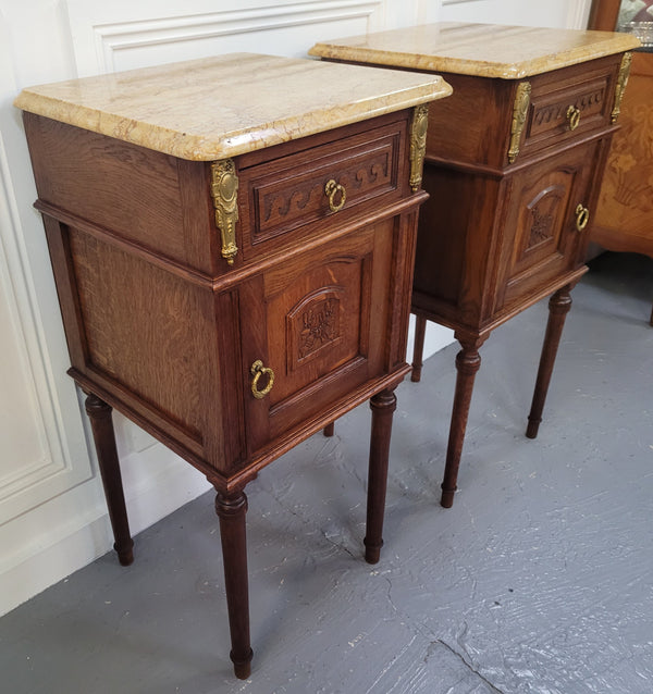 French Oak pair of Louis 16th style marble top bedsides with stunning bronze mounts. They have been sourced from France and are in good original detailed condition.