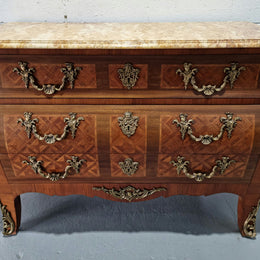 A beautifully inlaid parquetry three drawer commode with a lovely marble top, and decorative ormolu mounts. In good original detailed condition. Circa 1930