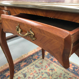 An impressive French Walnut petite Bureau Plat with superb ormolu mounts, original tooled leather top with loads of character and drawers for storage. It is in very good original detailed condition.