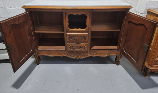 Lovely Louis XV style French Oak carved sideboard with two drawers and two cupboards for all your storage needs. It has a nice coloured marble top and in good original detailed condition.