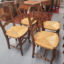 Set of six Louis XV style French Oak rush seat dining chairs. They are in good original detailed condition.