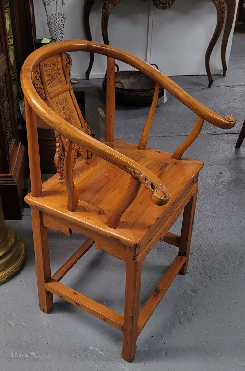 Lovely Chinese Elm horseshoe chair, featuring stunning carving and it is in good original detailed condition.